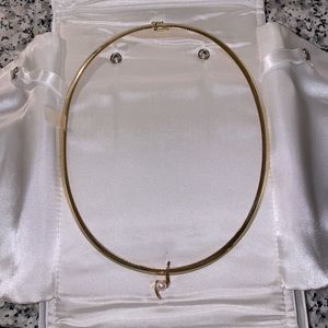 Gold necklace with pearl and diamond enhancer.